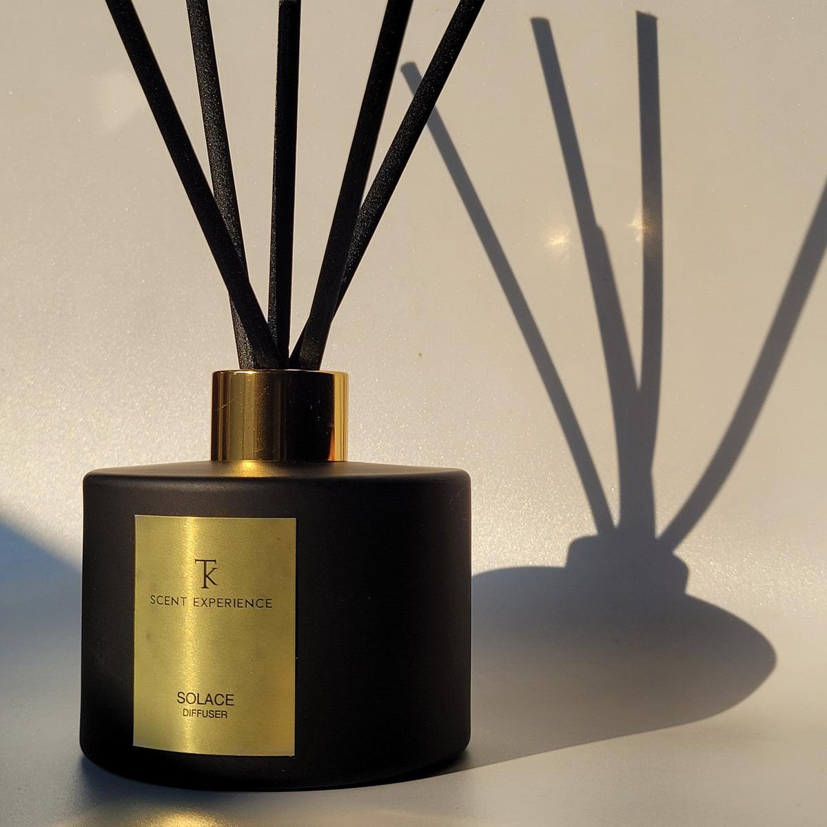 Solace luxury reed diffuser with blood orange and clove styled in a sophisticated home office