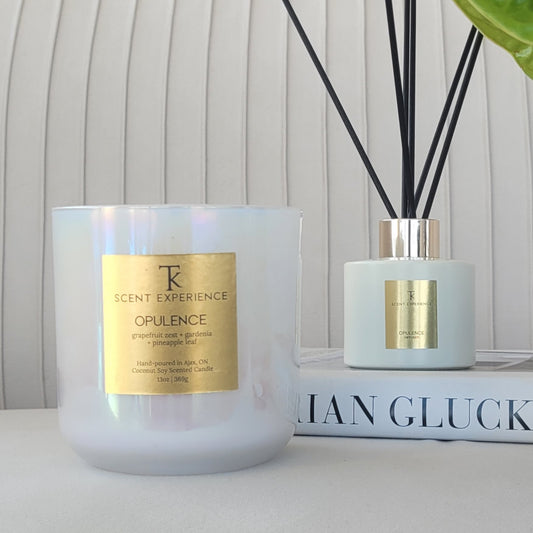 Close-up of Opulence candle and reed diffuser by TK Scent Experience with grapefruit, Persian lime, gardenia and pineapple leaf